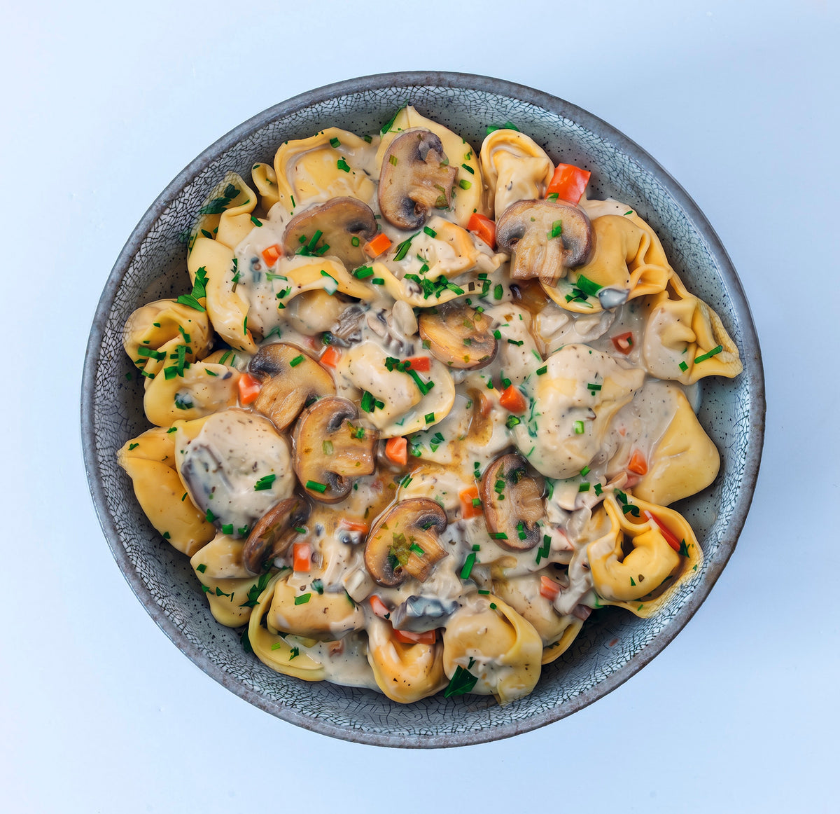 Bio Tortellini in cremiger Champignonsoße
